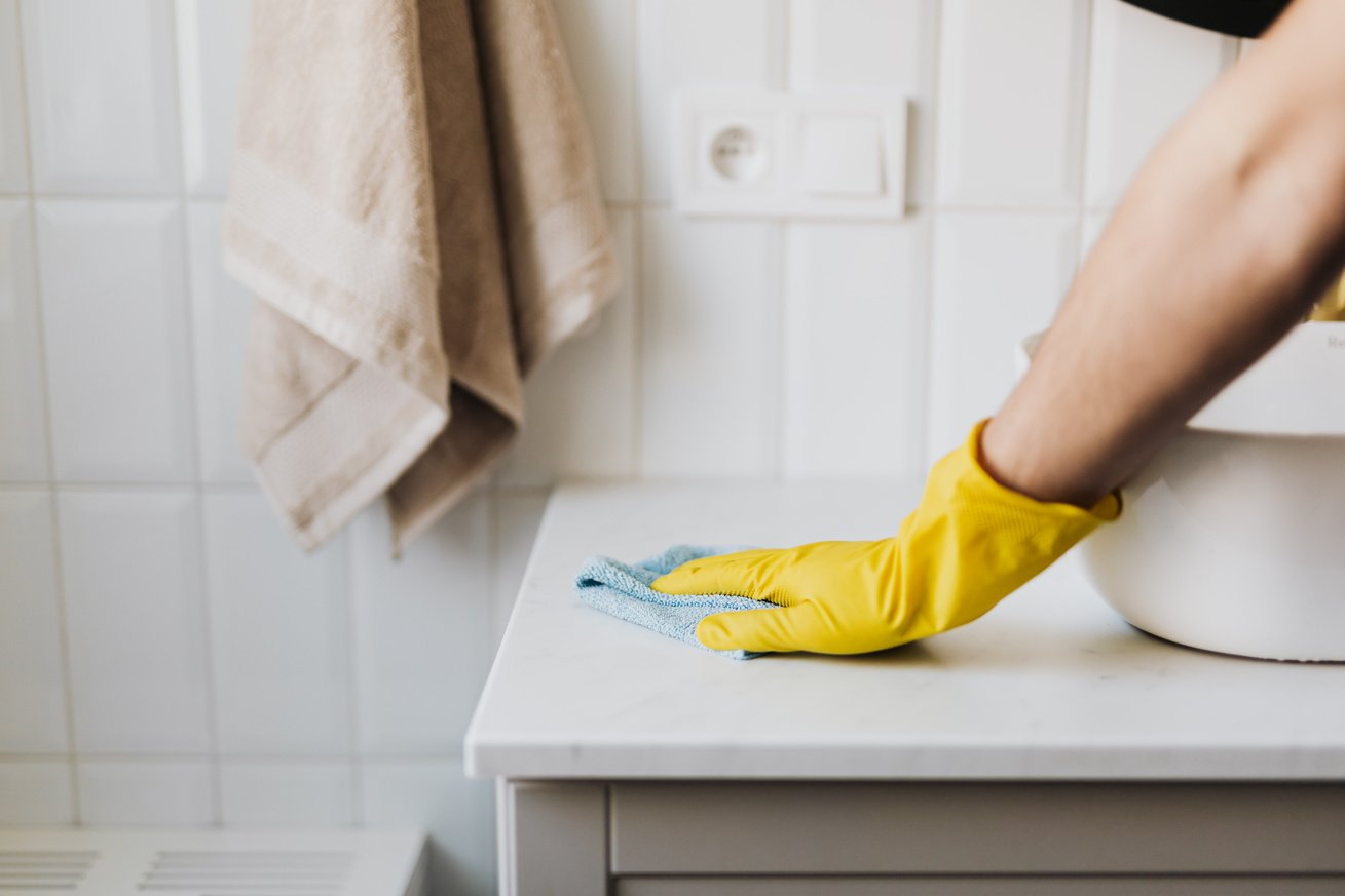 Crop Housemaker Cleaning Surface Near Sink